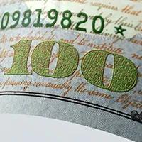 A close up of the two-tone ink on the 2013 $100 bill.